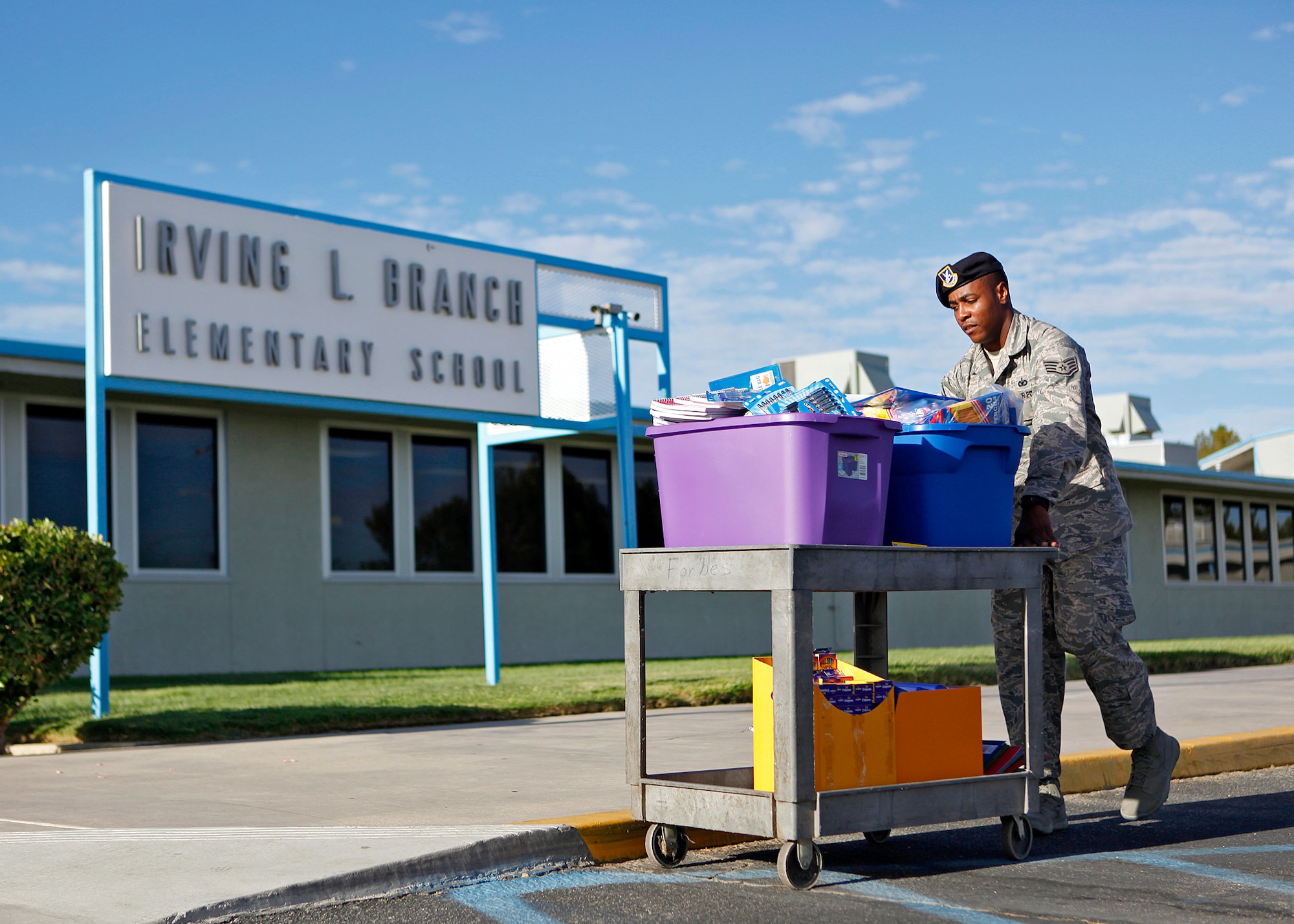 Staff Sgt. Devon Sumter, 412th Security Forces Squadron Pass and Identification clerk, carts in more than 200 school supply items that he has collected over the past year in order to donate it to Irving L. Branch Elementary School students and teachers Sep. 7, 2012. Ms. Kathleen Wilson, Irving L. Branch Elementary School principal, accepted the donations on behalf of the school. (U.S. Air Force photo by Jet Fabara)