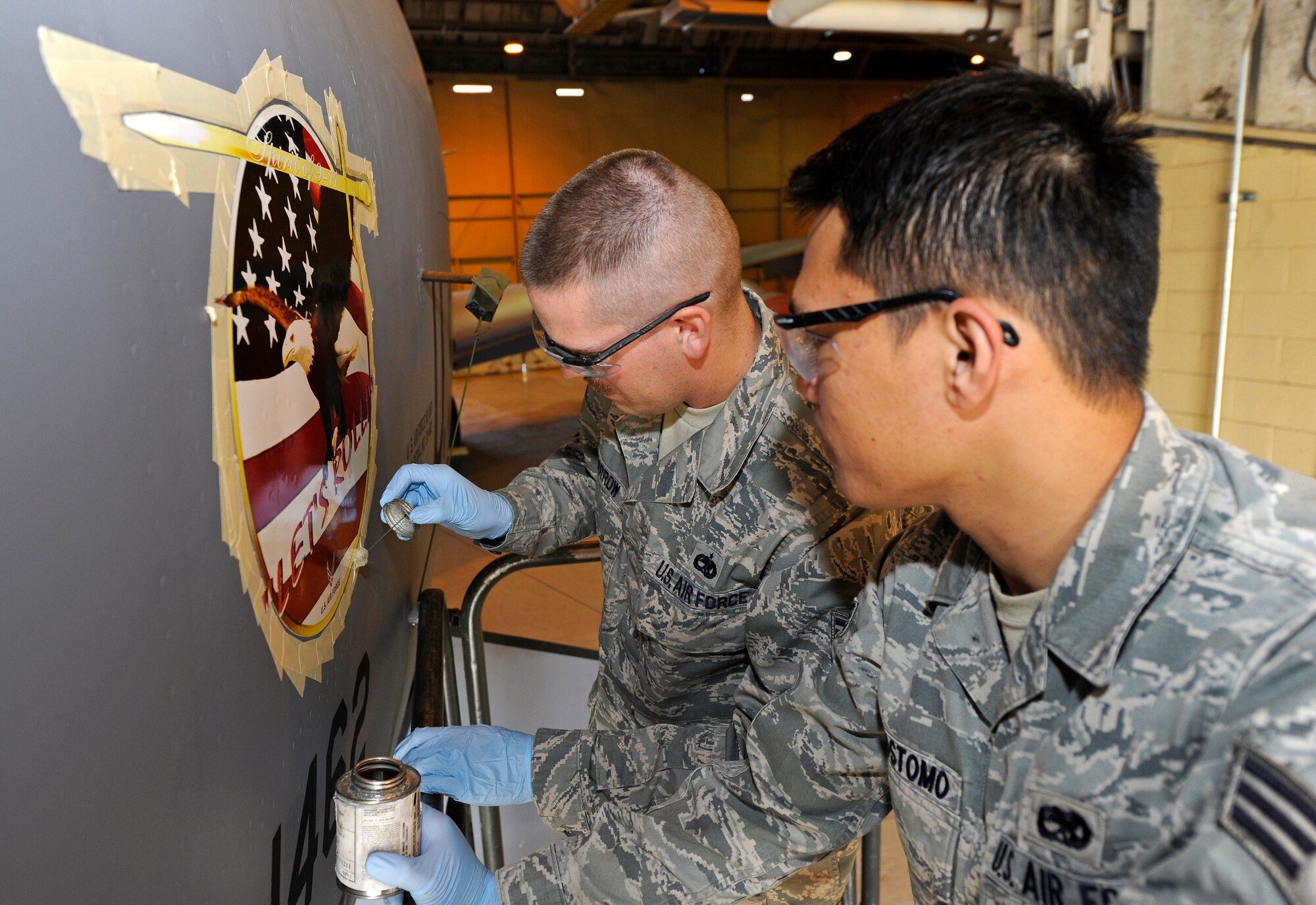 Staff Sgt. Michael O’Harrow and Senior Airman Chris Crisostomo, 92nd Maintenance Squadron aircraft structural mechanics, apply the ‘Let’s Roll’ emblem onto a Fairchild KC-135 Stratotanker at Fairchild Air Force Base, Wash., Sept. 10, 2012. The ‘Let’s Roll’ logo is placed in remembrance of those who died in the 2001 tragedy, 9/11. (U.S. Air Force photo by Airman 1st Class Ryan Zeski)
