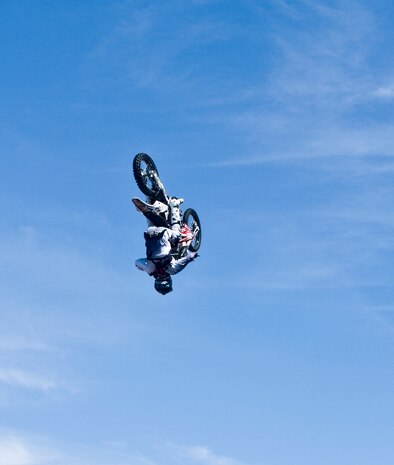 Keith Sayer, Red Bull Jams motocross rider, does a backflip on his bike for a crowd Sept. 8, 2012, at The Exchange here. Sayer started motocross in 1995 at 12 years old.  (U.S. Air Force photo by Senior Airman Jack Sanders)