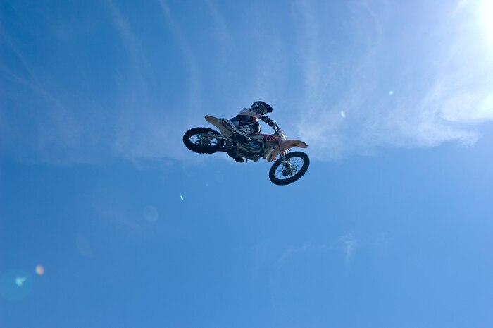 Keith Sayer, Red Bull Jams motocross rider, flys through the air after a jump Sept. 8, 2012, at The Exchange here. Red Bull Jams, a motocross tour designed to give back to troops and their families by performing at military installations, stopped at Nellis Air Force Base to put on a show for Airmen and their families here.(U.S. Air Force photo by Senior Airman Jack Sanders)