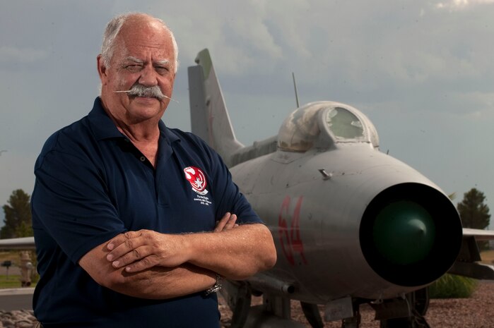Retired Air Force Col. Gaillard Peck Junior, former 4477th Test and Evaluation Squadron commander, poses for a photo in front of a static aircraft display Sept. 6, 2012, at Nellis Air Force Base, Nev. Peck is a former MiG-21 pilot assigned to Nellis AFB. (U.S. Air Force photo by Staff Sgt. Christopher Hubenthal)