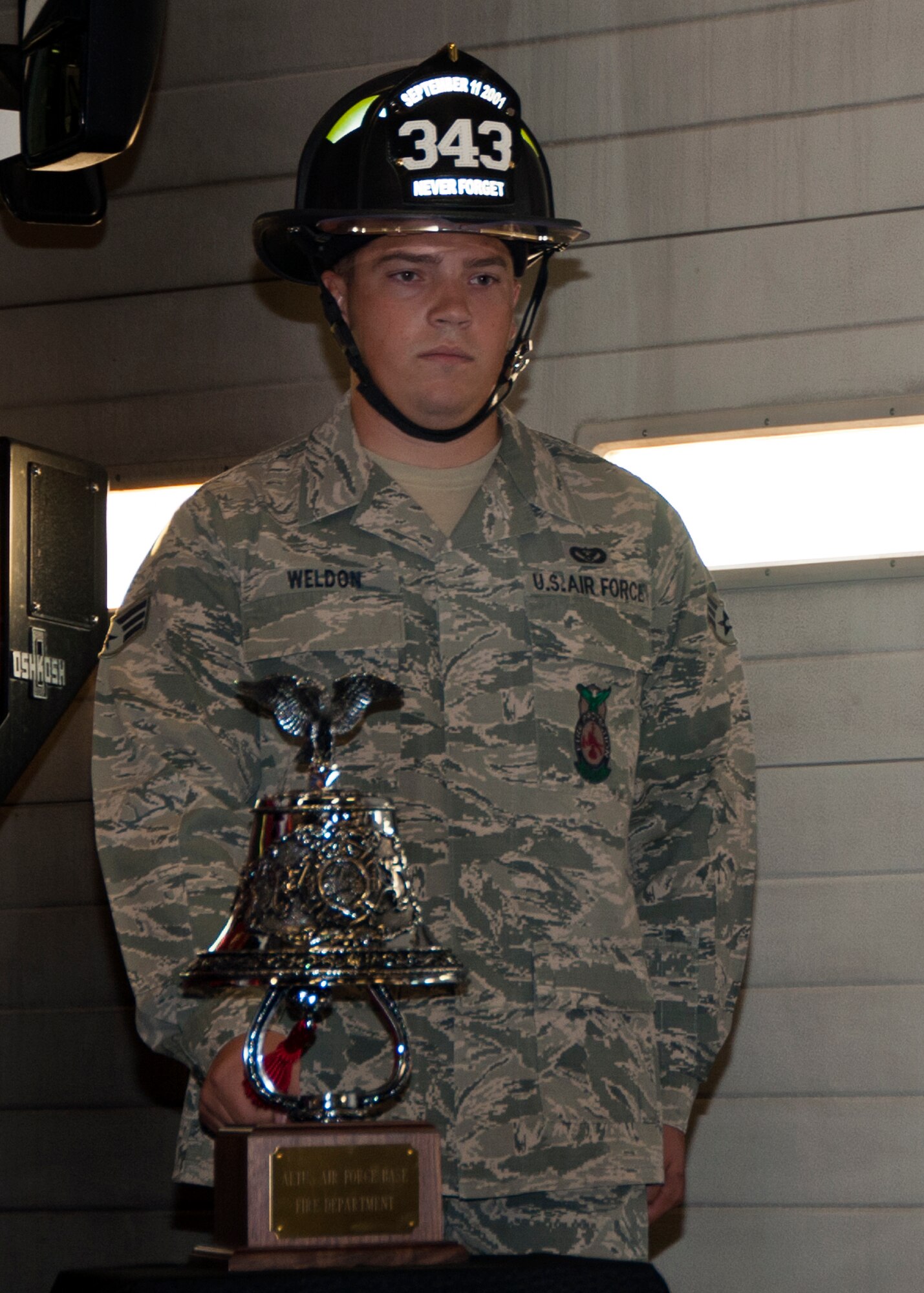 ALTUS AIR FORCE BASE, Okla. -- Senior Airman John Weldon, 97th Civil Engineer Squadron firefighter, rings a bell during The Last Alarm Ceremony at the base Fire Department, Sept. 11, 2012. The ceremony was conducted to honor the 343 firefighters who made the ultimate sacrifice Sept. 11, 2001. (U.S. Air Force photo by Senior Airman Kenneth W. Norman / Released / 97th Air Mobility Wing Public Affairs)