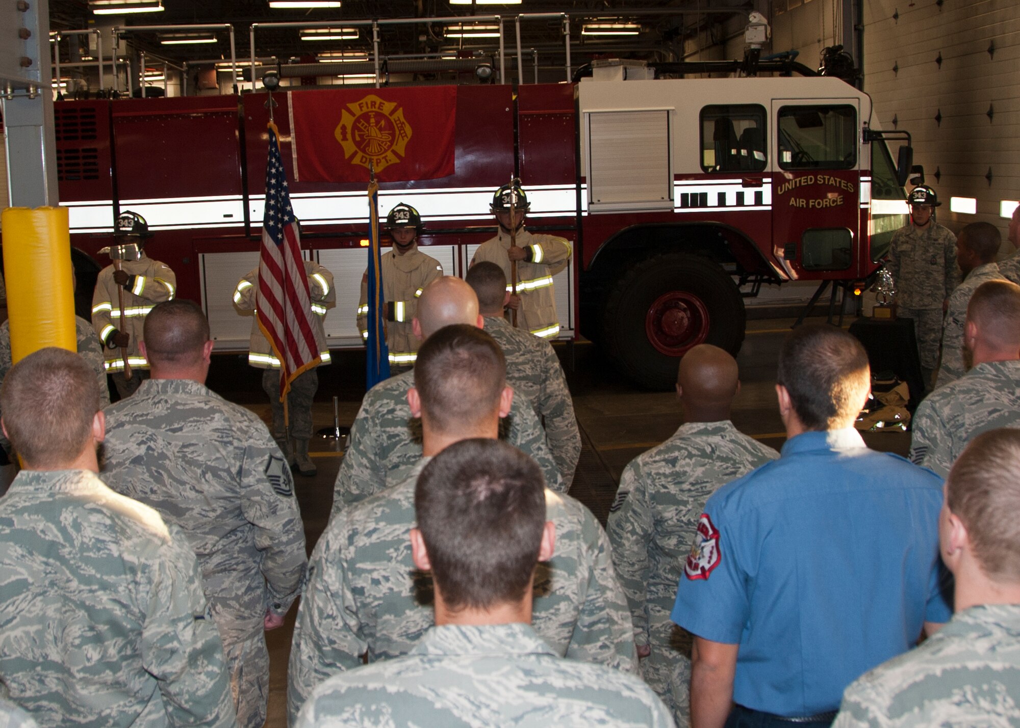 ALTUS AIR FORCE BASE, Okla. -- A formation of firefighters from the 97th Civil Engineer Squadron watch as the colors are posted during The Last Alarm Ceremony at the base Fire Department, Sept. 11, 2012. During the ceremony a bell was rung in a series of five rings, four times, to honor the 343 firefighters who gave their lives Sept. 11, 2001. (U.S. Air Force photo by Senior Airman Kenneth W. Norman / Released / 97th Air Mobility Wing Public Affairs)