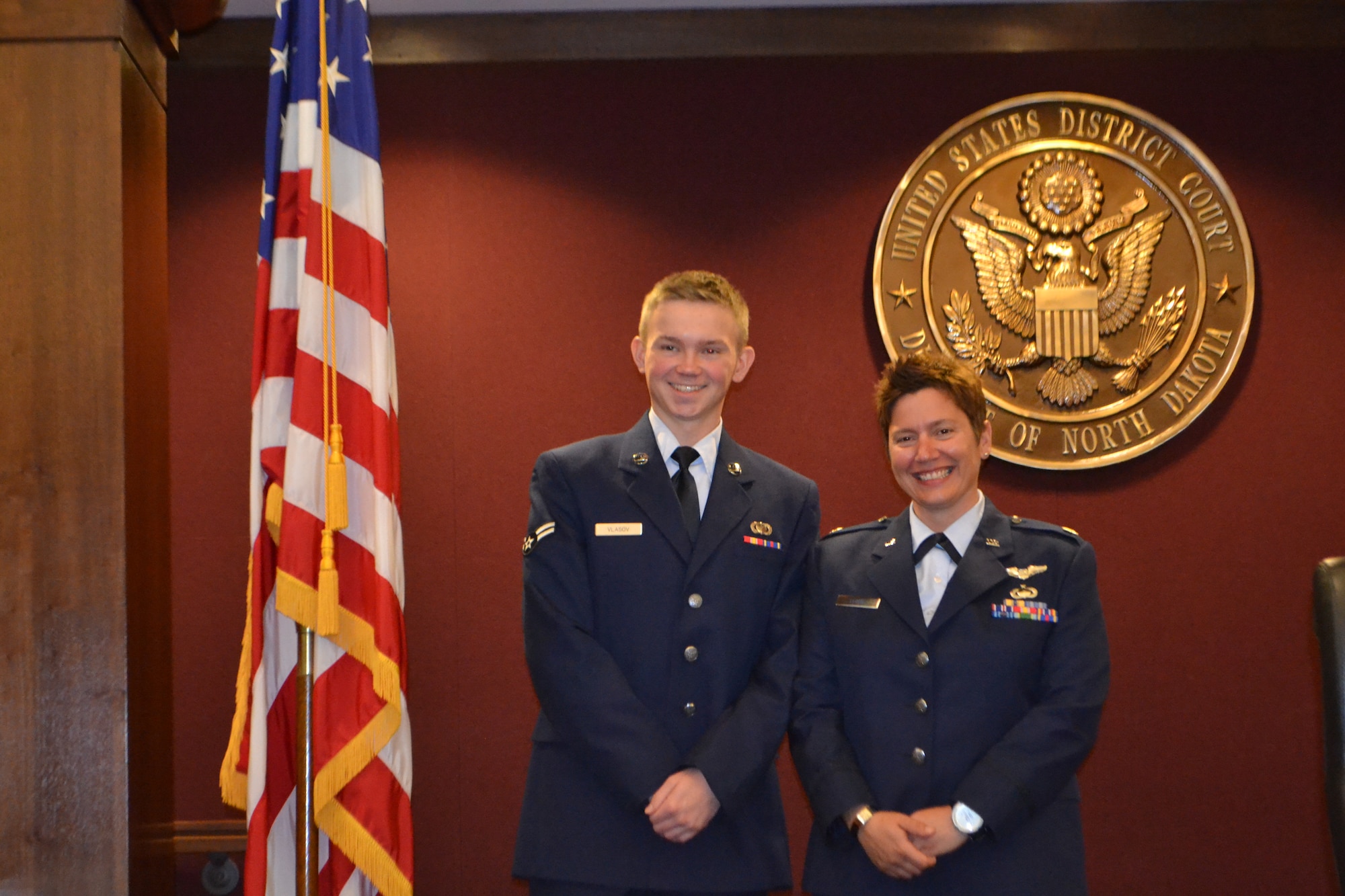 Maj. Wendy Leone, 319th Comptroller Squadron commander, stands alongside Airman 1st Class Nikolai Smirnoff, after he became a U.S. citizen during a naturalization ceremony,   Aug. 30, 2012, at the Quentin N. Burdick U.S. Courthouse in Fargo, N.D.  Smirnoff emigrated from Russia with his mother when he was 11 years old. He has since changed his last name from Vlasov to his mother’s maiden name, Smirnoff, in honor of his maternal grandmother who raised him for many years in Russia. (U.S. Air Force photo/Staff Sgt. Christina Groesbeck)