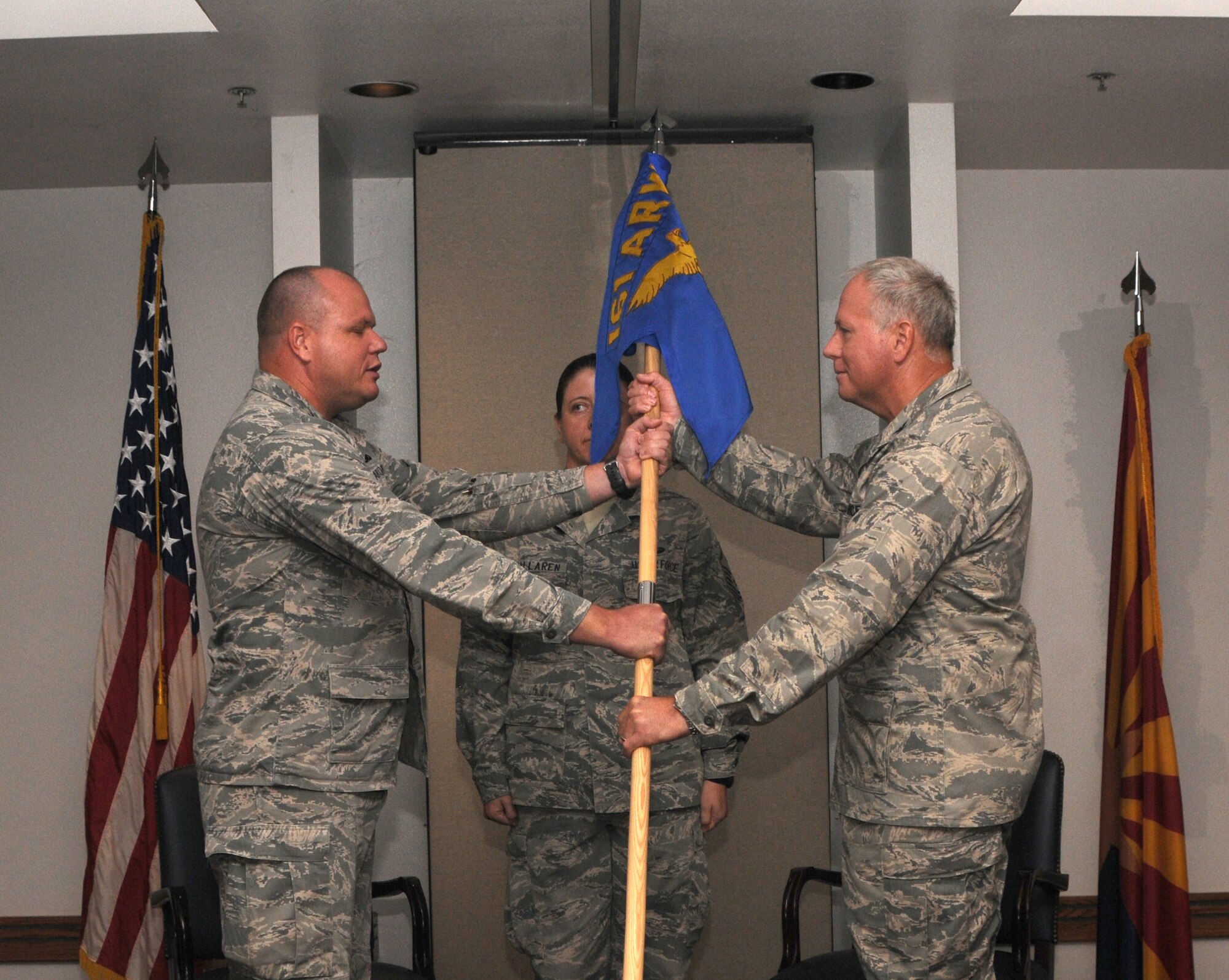 Col. Joseph B. Wilson accepts command of the 161st Maintenance Group from Col. Gary D. Brewer Jr., Sept. 8, 2012, at Phoenix Sky Harbor Air National Guard Base. Colonel Wilson’s previous assignment was as the Air National Guard Advisor to the commander, Oklahoma City Air Logistics Center, Tinker Air Force Base, Okla. (U.S. Air Force photo by Senior Airman Rashaunda Williams/Released)