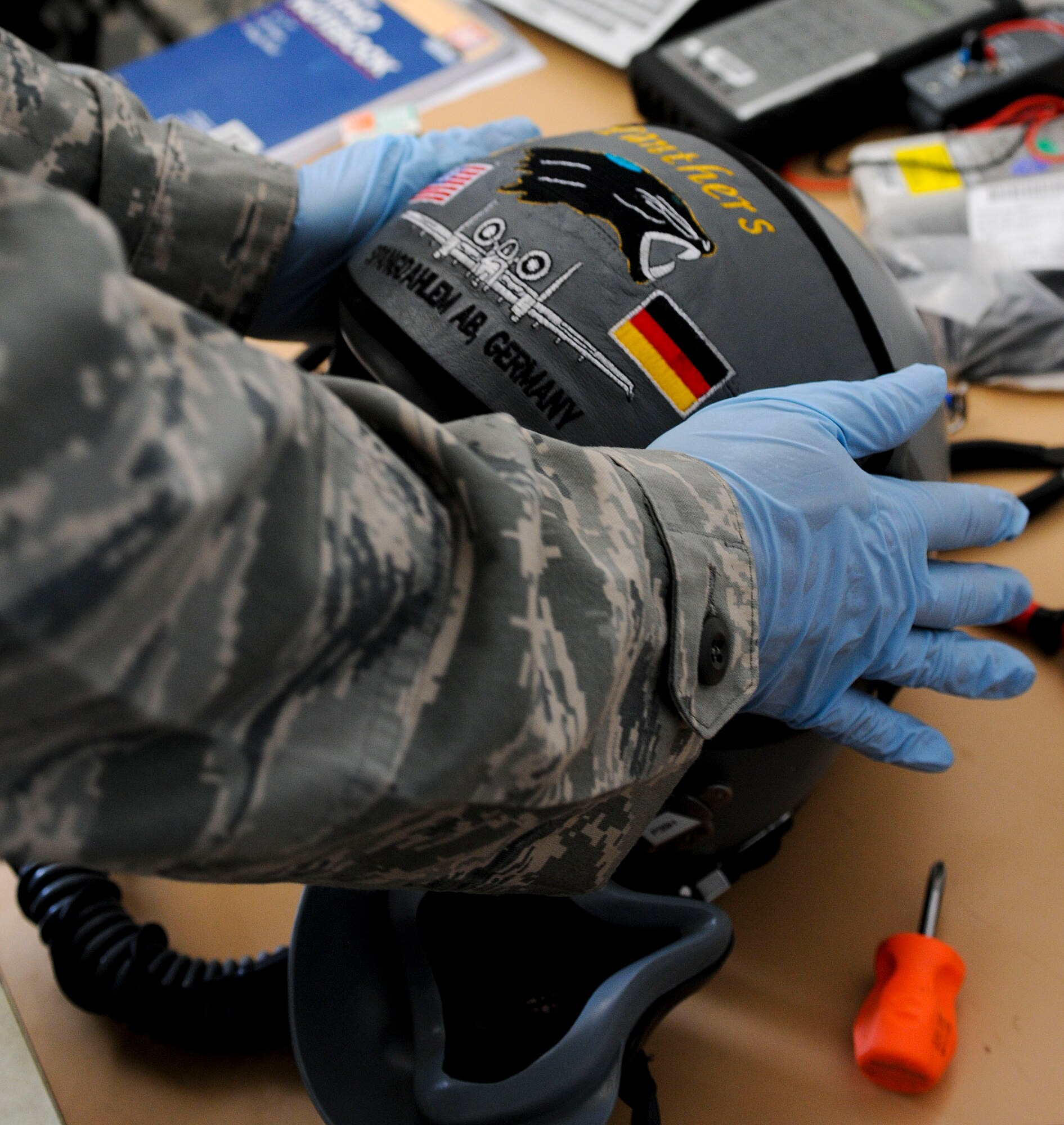 NAMEST AIR BASE, Czech Republic -- Senior Airman Brandon Keiper, 52nd Operations Support Squadron flight crew equipment maintainer, places a cover on the visor of an A-10 Thunderbolt II pilot's helmet as part of a 30 day inspection Sept. 10, during Ramstein Rover 2012 here. During these inspections, equipment maintainers disassemble and clean flight equipment to ensure the parts are ready for flying missions. RARO 12 is a NATO partnership building exercise invlolving more than 16 nations. A-10 Thunderbolt IIs from the 81st Fighter Squadron are participating in the exercise to provide close air support to partnering nations and practice forward air control missions with their NATO allies in international sercurity assistance force realistic scenarios. Participating in exercises like RARO 12 ensures effective employment of airpower in support of alliance or coallition forces while mitigating risks to civilians in contingency operations. (U.S. Air Force photo by Senior Airman Natasha Stannard/Released)