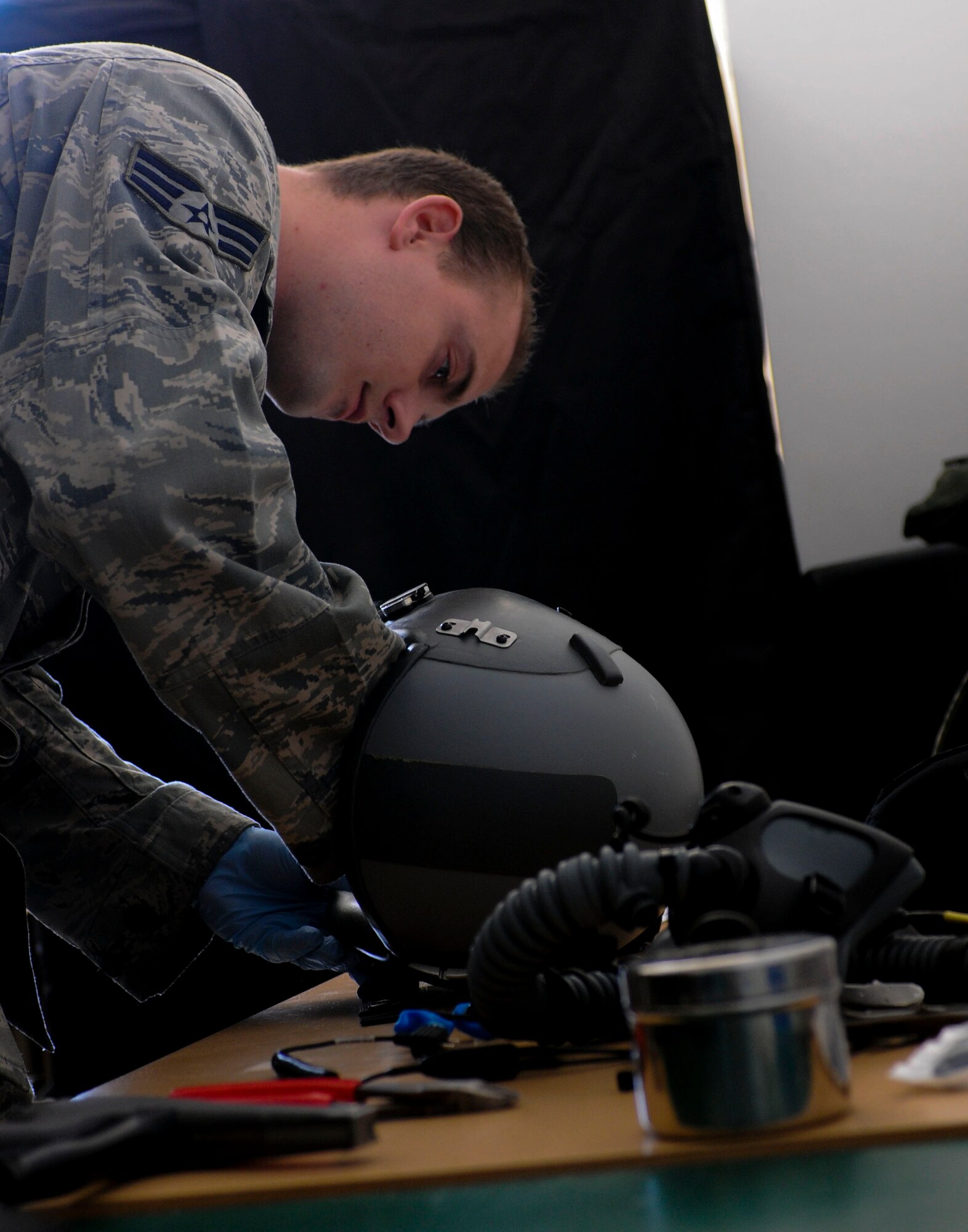 NAMEST AIR BASE, Czech Republic -- Senior Airman Brandon Keiper, 52nd Operations Support Squadron flight crew equipment maintainer, adjusts parts of a pilot's helmet as part of a 30-day inspection Sept. 10, during Ramstein Rover 2012 here.The 81st Fighter sqaudron is participating in RARO 12 to build partnerships and exchange tactics techniques and procedures with more than 16 NATO nations. A-10 Thunderbolt IIs from the 81st Fighter Squadron are providing close air support to partnering nations and practicing forward air control missions with their NATO allies in international security assistance force realistic scenarios throughtout the exercise. Participating in exercises like RARO 12 ensures effective employment of airpower in support of alliance or coalition forces while mitigating risks to civilians in contingency operations. (U.S. Air Force photo by Senior Airman Natasha Stannard/Released)