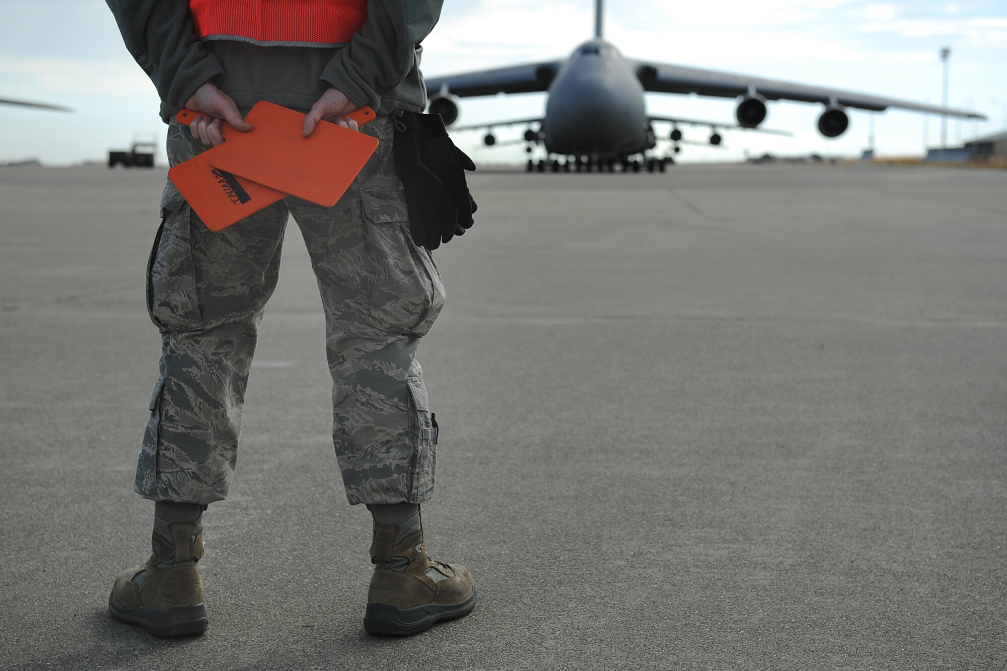A 621st Contingency Response Wing member waits to marshal out a departing C-5 Galaxy during Exercise Gladiator Challenge. The exercise scenario included the CRW providing a contingency response team to respond to a simulated devastating earthquake in the San Francisco Bay area, which displaced 750, 000 simulated people. (U.S. Air Force Photo/MSgt Stan Parker)