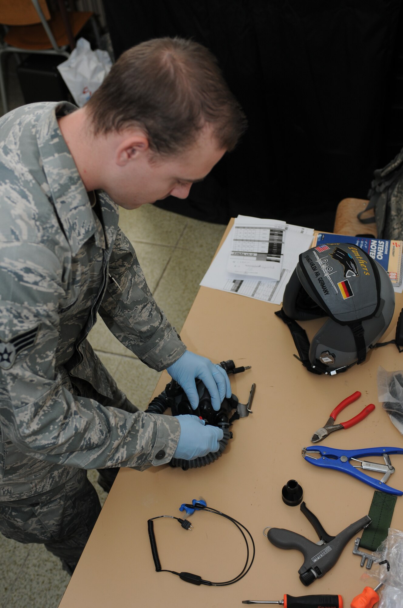 NAMEST AIR BASE, Czech Republic -- Senior Airman Brandon Keiper, 52nd Operations Support Squadron flight crew equipment maintainer, takes apart a pilot's helmet for inspection Sept. 10, during Ramstein Rover 2012 here. Flight crew equiment maintainers must check equipment every 30 days to ensure it is suitable for flying operations. RARO 12 is a NATO partnership building exercise invlolving more than 16 nations.A-10 Thunderbolt IIs from the 81st Fighter Squadron are providing close air support to partnering nations and practicing forward air control missions with their NATO allies in international security assistance force realistic scenarios throughtout the exercise. Participating in exercises like RARO 12 ensures effective employment of airpower in support of alliance or coalition forces while mitigating risks to civilians in contingency operations. (U.S. Air Force photo by Senior Airman Natasha Stannard/Released)