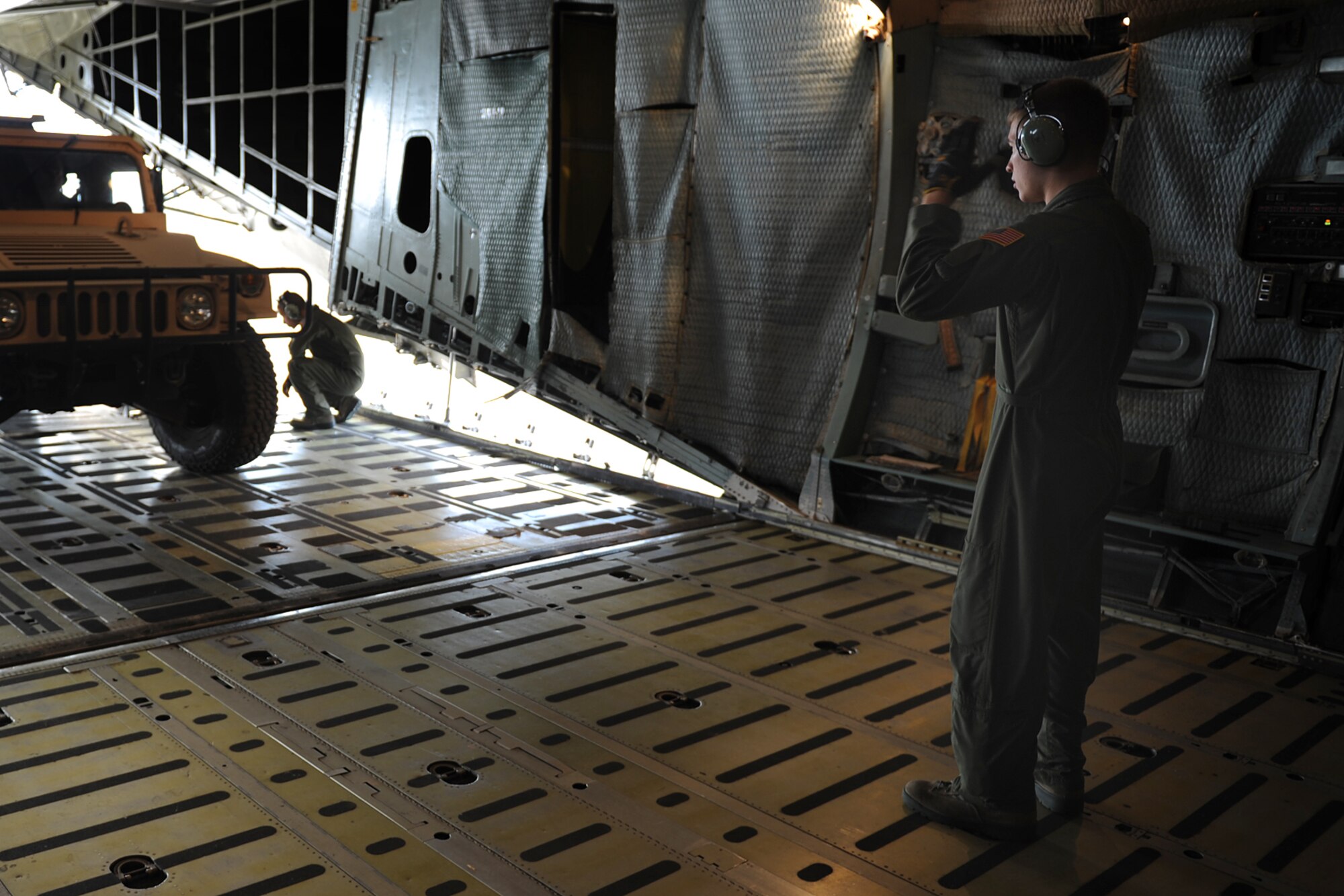 Senior Airman John Krueger, 22nd Airlift Squadron, marshals on a HUMVEE aboard a C-5 Galaxy during Exercise Gladiator Challenge. The exercise scenario included the CRW providing a contingency response team to respond to a simulated devastating earthquake in the San Francisco Bay area, which displaced 750, 000 simulated people. (U.S. Air Force Photo/MSgt Stan Parker)