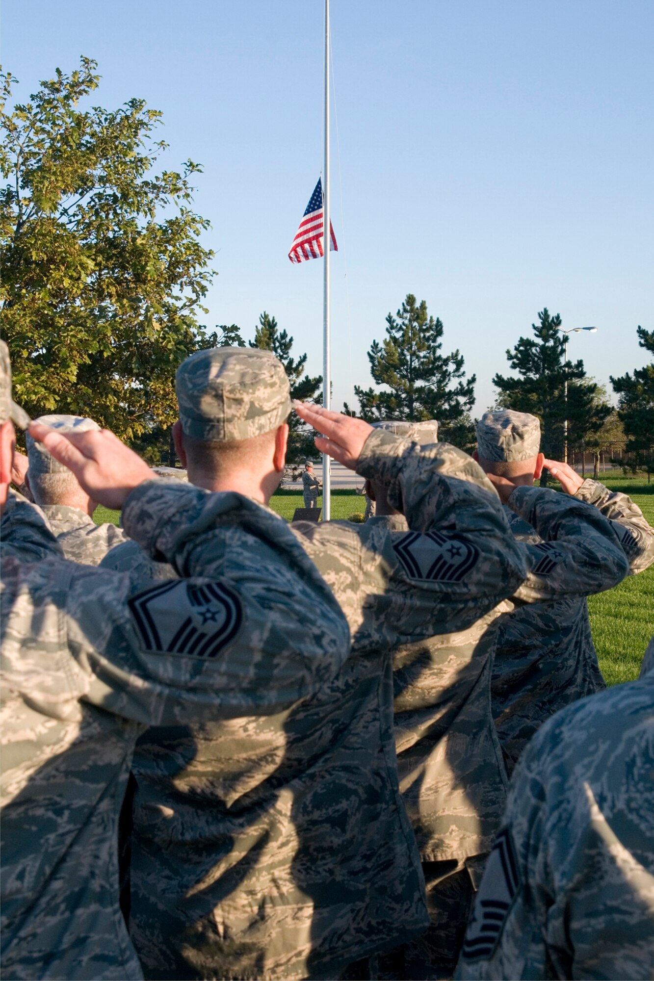 GRISSOM AIR RESERVE BASE, Ind. -- 434th Air Refueling Wing Airmen salute an American Flag as it is raised and then lowered to half-staff during morning reveille here Sept. 11. More than 100 wing members stood in formation together to remember the victims of the terrorist attacks that took place 11 years ago. (U.S. Air Force photo/Senior Airman Andrew McLaughlin) 