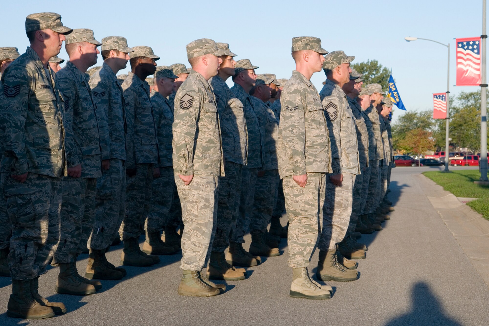 GRISSOM AIR RESERVE BASE, Ind. -- 434th Air Refueling Wing Airmen stand at attention before an American Flag is raised during morning reveille here Sept. 11. More than 100 wing members stood in formation together to remember the victims of the terrorist attacks that took place 11 years ago. (U.S. Air Force photo/Senior Airman Andrew McLaughlin) 
