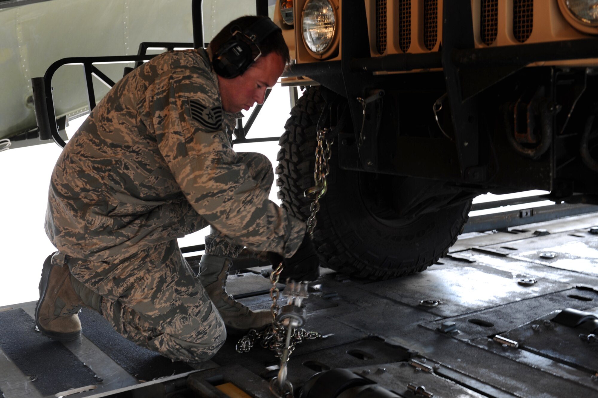 Tech. Sgt. Jason Rictor, 571st Global Mobility Squadron, ensures cargo is secured aboard a C-5 Galaxy during Exercise Gladiator Challenge. The exercise scenario included the CRW providing a contingency response team to respond to a simulated devastating earthquake in the San Francisco Bay area, which displaced 750, 000 simulated people. (U.S. Air Force Photo/MSgt Stan Parker)