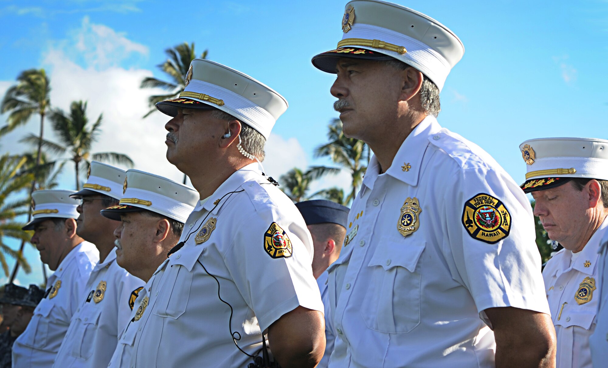 Federal Fire Department members, alongside U.S. military members, pay their respects during a Sept. 11th Remembrance Ceremony on Joint Base Pearl Harbor-Hickam, Hawaii, Sept. 11, 2012. This year marks the 11th anniversary of the attacks on the World Trade Center, the Pentagon, and the crash in Shanksville, Pennsylvania. (U.S. Air Force photo/Senior Airman Lauren Main)
