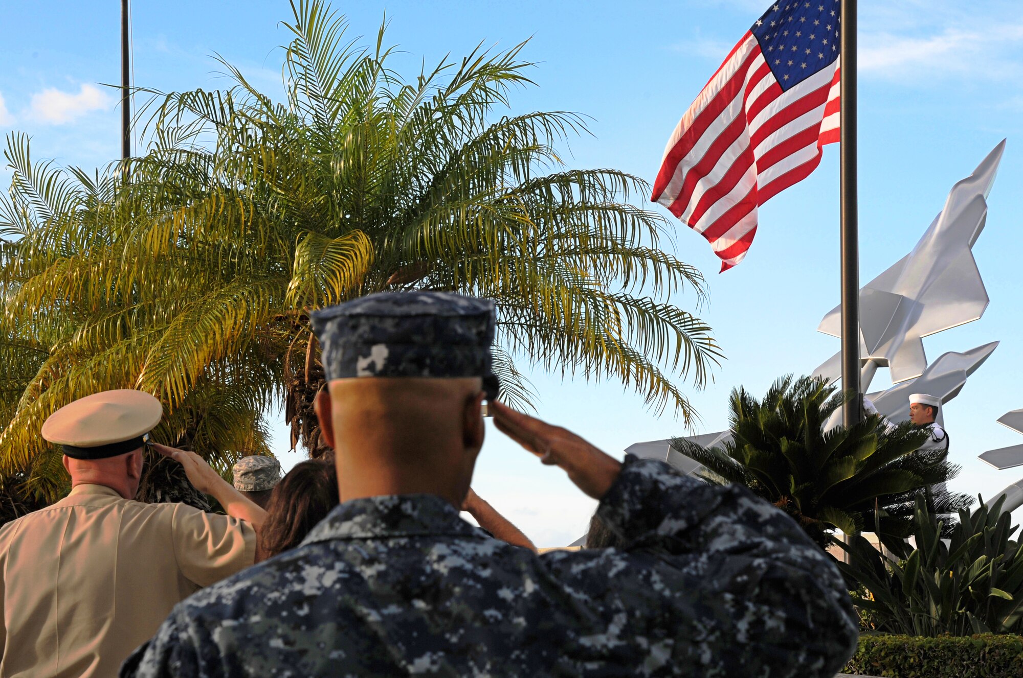 U.S. military members, alongside Federal Fire Department members, pay their respects during a Sept. 11th Remembrance Ceremony on Joint Base Pearl Harbor-Hickam, Hawaii, Sept. 11, 2012. This year marks the 11th anniversary of the attacks on the World Trade Center, the Pentagon, and the crash in Shanksville, Pennsylvania. (U.S. Air Force photo/Senior Airman Lauren Main)