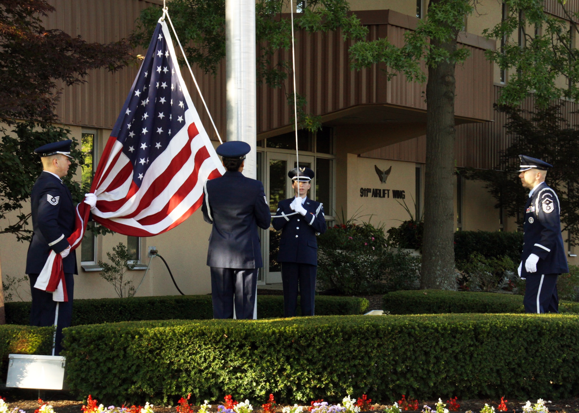 Members of the 911th Airlift Wing Honor Guard stand ready to raise the American Flag to half-staff, during a 9/11 memorial ceremony held on base, Sept. 11, 2012. Formations of military and civilian personnel filled the street in front of the Headquarters building, where the ceremony was held.  Col. Craig C. Peters, 911th Airlift Wing commander, delivered a few remarks at the beginning of the ceremony before turning it over to Chaplain (Maj.) Brad Davis, who led the group in prayer, which was then followed by a brief moment of silence.  The moment of silence coincided with the time the first plane hit the World Trade Center and throughout the morning the base conducted four other moments of silence, each one held at the time the other planes crashed. (U.S. Air Force photo by Capt. Shawn M. Walleck/Released)  