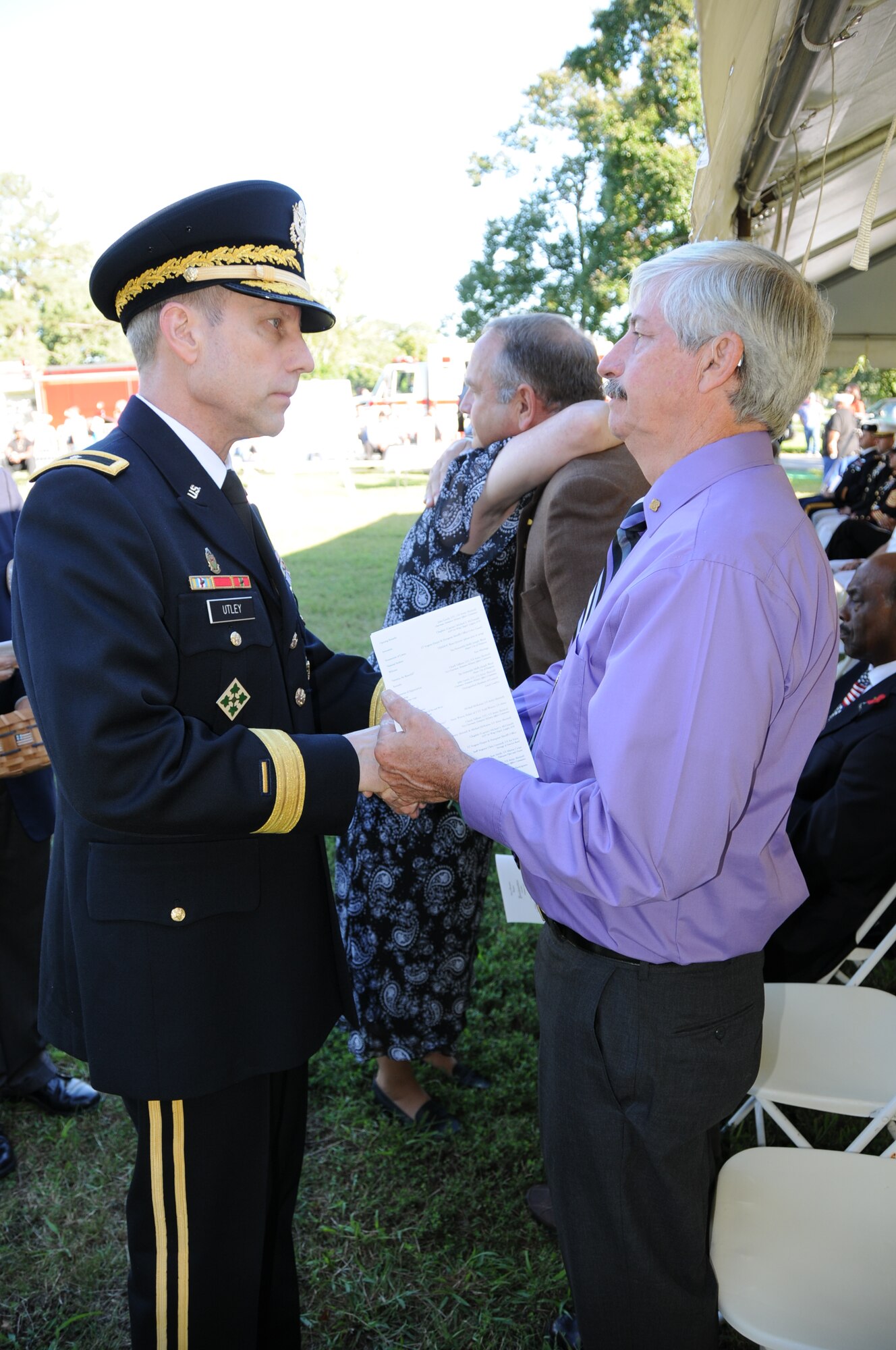 Brig. Gen. Pete Utley, U.S. Army Training and Doctrine Command's deputy chief of staff for operations and training, consoles retired Navy Senior Chief Petty Officer Larry Sticklen, who lost his son in the attacks on Sept. 11, during the 11th Annual Day of Remembrance and Hope ceremony, Sept. 11, 2012, at Gosnold Hope Park, Hampton, Va.(U.S. Army photo by Sgt. 1st Class Kelly Jo Bridgwater/Released)