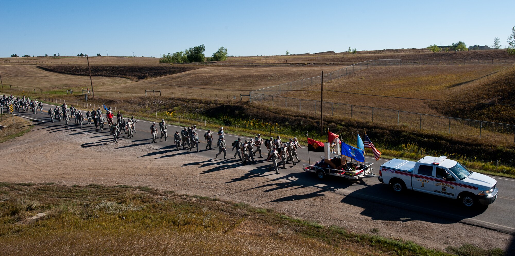 A multitude of nearly 150 Airmen and first responders from surrounding communities begin their 11-mile trek during a 9/11 Remembrance Ruck March on Ellsworth Air Force Base, S.D., Sept. 8, 2012. The participants traveled from the Pride Hangar, out the base's commercial gate and down the service road along Interstate 90, concluding their march with a special ceremony at an area shopping center as part of a Disaster Awareness and Safety Day organized by the Rapid City Pennington County Emergency Management Office to honor the 11th anniversary of the 9/11 terrorist attacks. (U.S. Air Force photo by Airman 1st Class Kate Thornton-Maurer)