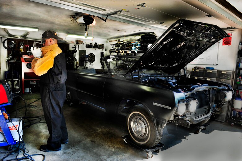 Staff Sgt. Raul Chavez puts on protective gear before he begins welding a door on a 1963 impala convertible in his “man cave” August 30, 21012. For the past 21 years, in his spare time, Chavez finds projects to restore to keep him busy in his man-cave, not just car restorations. (U.S. Air Force photo/ Staff Sgt. Stephenie Wade)