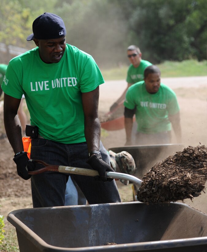 Ellsworth Airmen teamed up with community volunteers to complete a project at the South Dakota Game, Fish and Parks Outdoor Campus West in Rapid City, S.D., during the United Way of the Black Hills Day of Caring Sept. 6, 2012. During the Day of Caring, Airmen and other volunteers actively gave back to their community through various projects around the area, including washing windows, cleaning gutters, mowing lawns, putting up chain-link fences and painting homes. (U.S. Air Force photo by Airman 1st Class Hrair H. Palyan/Released)