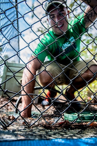 Senior Airman Alex Castillo, 437th Aircraft Maintenance Squadron jet mechanic, unhooks a hose he was using for power washing Sept. 7, 2012, at the Miracle League Ball Park in Summerville, S.C. Castillo and several other Airmen from the 437th Airlift Wing volunteered to prepare the park for the upcoming season. The Miracle League provides opportunities for individuals with disabilities to play baseball. The Day of Caring, organized locally by the Trident United Way, saw more than 8,500 volunteers working on more than 300 projects around the Lowcountry. (U.S. Air Force photo/Senior Airman Dennis Sloan)