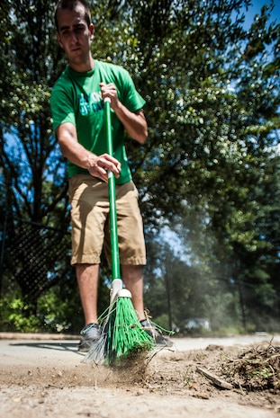 Senior Airman Zach Brammer, 437th Aircraft Maintenance Squadron crew chief, sweeps sidewalks Sept. 7, 2012, at the Miracle League Ball Park in Summerville, S.C. Brammer and several other Airmen from the 437th Airlift Wing volunteered to prepare the park for the upcoming season. The Miracle League provides opportunities for individuals with disabilities to play baseball. The Day of Caring, organized locally by the Trident United Way, saw more than 8,500 volunteers working on more than 300 projects around the Lowcountry. (U.S. Air Force photo/Senior Airman Dennis Sloan)