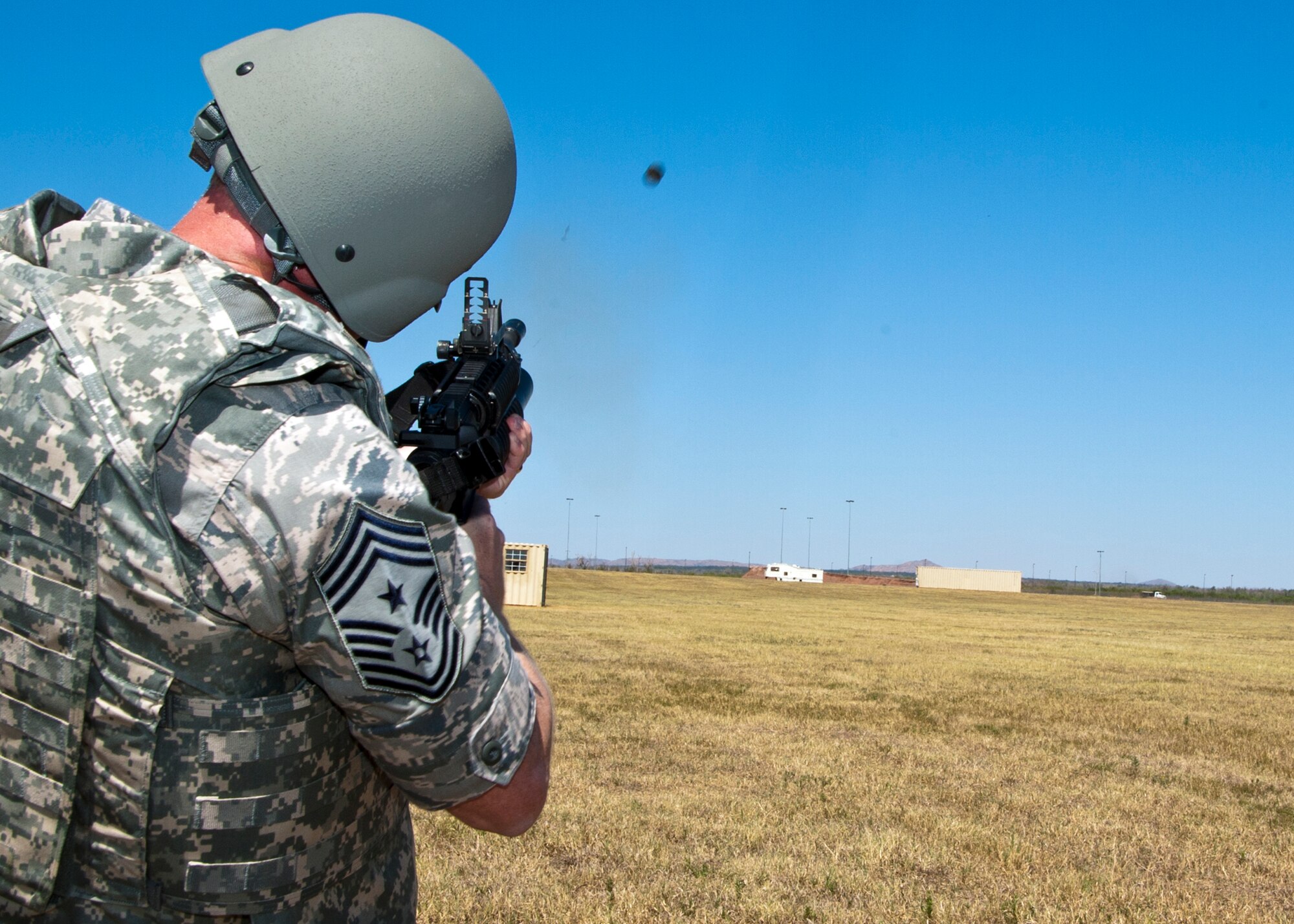 ALTUS AIR FORCE BASE, Okla. -- Chief Master Sgt. James Cody, command chief of Air Education and Training Command, fires an M203 Grenade Launcher at the new M203 firing range, Sept. 10, 2012.  During his visit Cody spoke with Airmen at an All Call, toured squadrons throughout the base, utilized the M203 firing range and attended a deployed spouses dinner. (U.S. Air Force photo by Senior Airman Kenneth W. Norman / Released / 97th Air Mobility Wing Public Affairs)