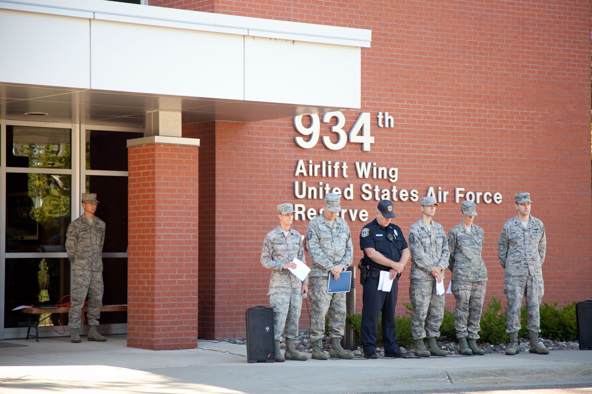 Readers during a Remembrance Ceremony at the 934th Airlift Wing observe a moment of silence in honor of those lost 9/11.  The wing held the ceremony on Sunday over the Unit Training Assembly weekend.  (U.S. Air Force Photo/Shannon McKay)