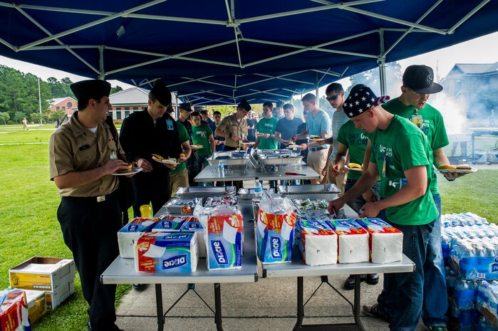 Day of Caring volunteers eat, socialize and play games at the "Barracks Bash" celebration Sept. 7, 2012, at Joint Base Charleston - Weapons Station, S.C. The Day of Caring, organized locally by the Trident United Way, saw more than 8,500 volunteers working on more than 300 projects around the Lowcountry. (U.S. Air Force phot/Airman 1st Class George Goslin)