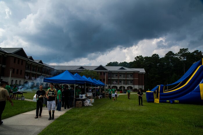 Day of Caring volunteers eat, socialize and play games at the "Barracks Bash" celebration Sept. 7, 2012, at Joint Base Charleston - Weapons Station, S.C. The Day of Caring, organized locally by the Trident United Way, saw more than 8,500 volunteers working on more than 300 projects around the Lowcountry. (U.S. Air Force photo/Airman 1st Class George Goslin)