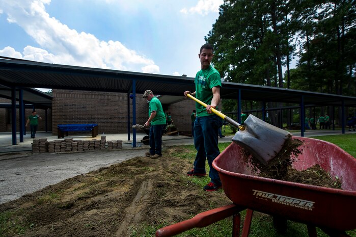 Seaman Ryan Jordan, Naval Nuclear Power Training Command Machinist’s Mate student, shovels dirt at Marrington Middle School during the Day of Caring Sept. 7, 2012, at Joint Base Charleston - Weapons Station, S.C. The Day of Caring, organized locally by the Trident United Way, saw more than 8,500 volunteers working on more than 300 projects around the Lowcountry. (U.S. Air Force photo/Airman 1st Class George Goslin)