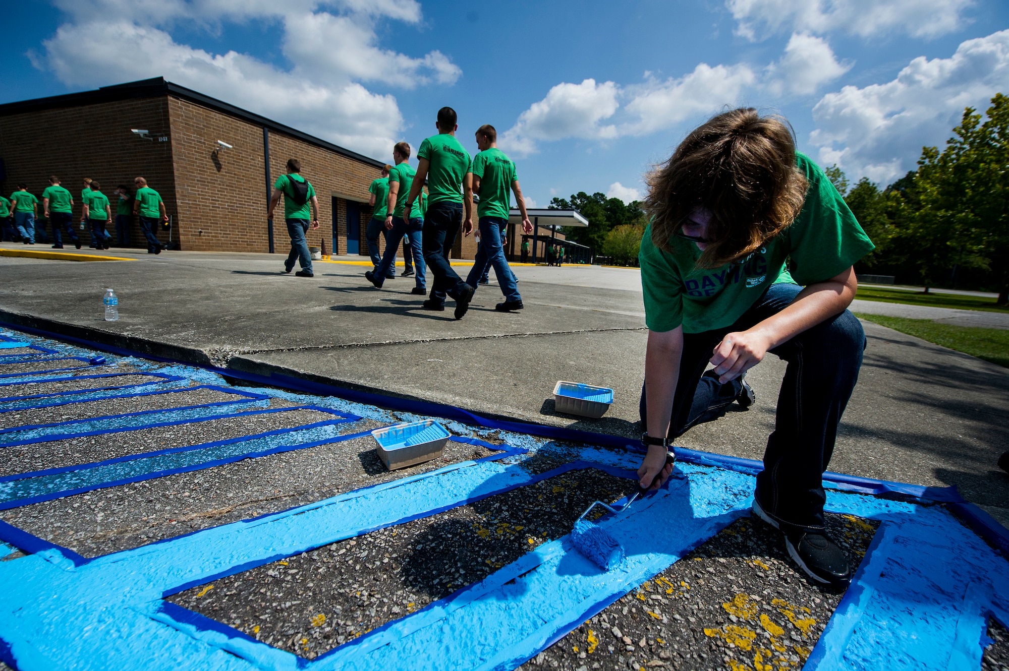 Seaman Cisile Taft, Naval Nuclear Power Training Command Electrician’s Mate student, paints handicapped parking lines at Marrington Elementary School during the Day of Caring Sept. 7, 2012, at Joint Base Charleston - Weapons Station, S.C. The Day of Caring, organized locally by the Trident United Way, saw more than 8,500 volunteers working on more than 300 projects around the Lowcountry. (U.S. Air Force photo/Airman 1st Class George Goslin)