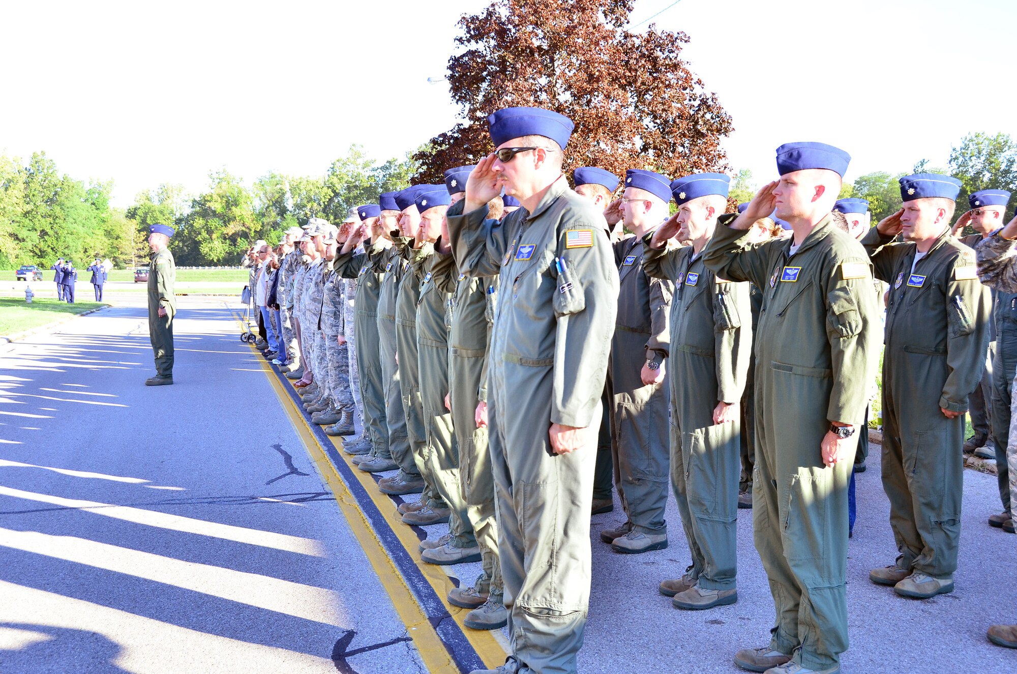 WRIGHT-PATTERSON AIR FORCE BASE, Ohio – The men and women from 445th Airlift Wing render a salute as the 445th AW Honor Guard raises and lowers the flag to half staff at the start of the wing’s Patriot Day ceremony at the 445th AW Headquarters building Sept. 11, marking the eleven year anniversary of the attacks. (U.S. Air Force photo/Stacy Vaughn)