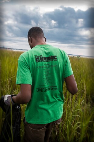 Senior Airman Reco Webb, 628th Medical Group medical technician, picks up debris Sept. 8, 2012, along the muddy banks of the Waterfront Park in downtown Charleston, S.C. The Waterfront Park cleanup was coordinated with the help of “Keep Charleston Beautiful,” a non-profit organization dedicated to promoting the cleanliness and beautification of the City of Charleston through education, public awareness and community involvement. The Day of Caring, organized locally by the Trident United Way, saw more than 8,500 volunteers working on more than 300 projects around the Lowcountry.
(U.S. Air Force photo / Airman 1st Class Tom Brading)
