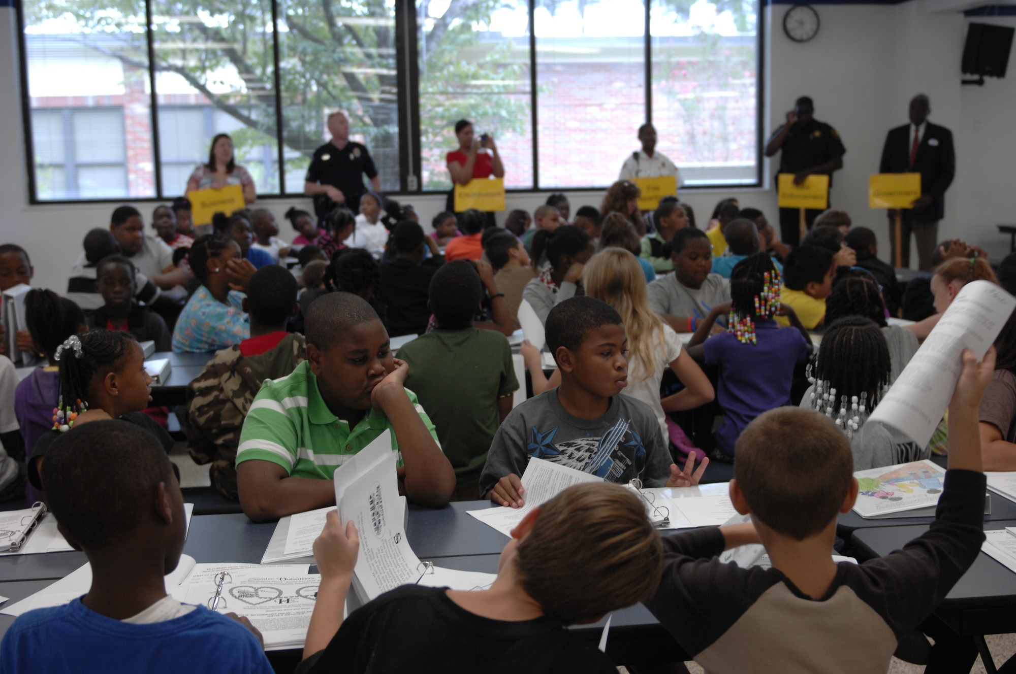 Team Shaw Airmen and Sumter community members gather at Wilson Drive Elementary School, Sumter, S.C., to speak to fourth graders about their jobs and their role in the community Sept. 6, 2012. The event kicked off a program called My Community and Me, and the goal was to teach the students how to be good leaders in the community and to expand their knowledge of the community. My Community and Me will continue until Oct. 11. (U.S. Air Force photo by Airman 1st Class Krystal M. Jeffers/Released)