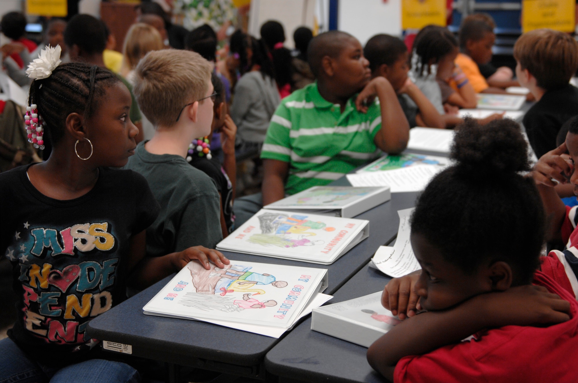 Fourth graders from Wilson Drive Elementary School, Sumter, S.C., gather at their school?s cafeteria to meet with community members and Team Shaw Airmen for a program called My Community and Me Sept 6, 2012. The program entailed members from throughout the community, including service members from Shaw Air Force Base, S.C., meeting with fourth graders at different schools and talking to the students about their jobs. (U.S. Air Force photo by Airman 1st Class Krystal M. Jeffers/Released)
