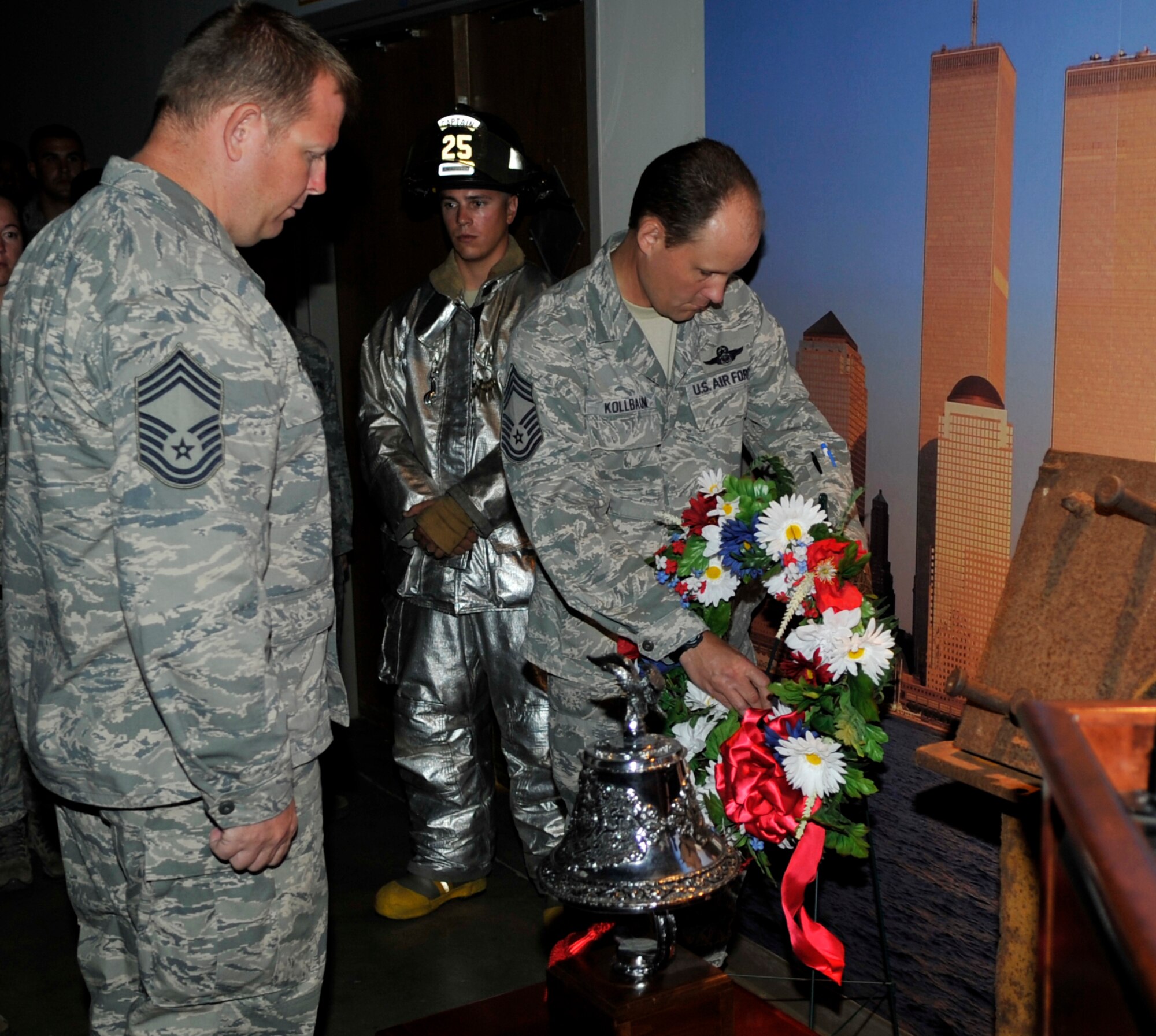 Chief Master Sgt. Samuel Fredrick, 61st Airlift Squadron superintendent, and Chief Master Sgt. Gregg Kollbaum, 314th Airlift Wing interim command chief, place a wreath during a 9/11 memorial tribute at the Mobility Processing Center Sept. 11, 2012, at Little Rock Air Force Base, Ark. The tribute was done to remember and honor fallen from the attack on the World Trade Center Sept. 11, 2001 (U.S. Air Force photo by Staff Sgt. Caleb Pierce)