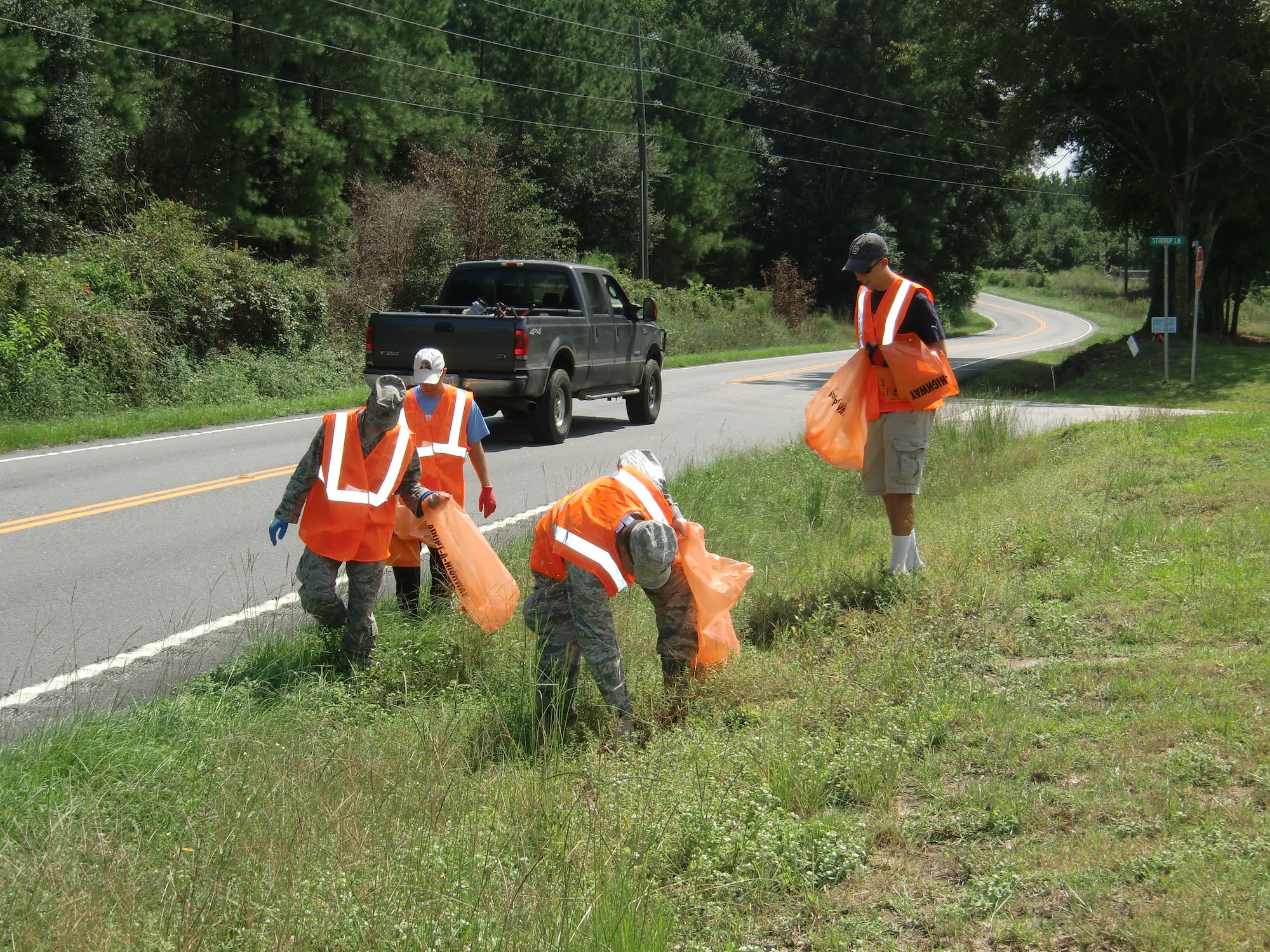 Members of the Company Grade Officers Council pick up trash along a one-mile stretch of highway, Shaw Air Force Base, S.C., Sept. 7, 2012. The group collected and bagged trash along both sides of the highway in conjunction with the state’s Adopt-A-Highway program. (U.S. Air Force photo courtesy of Capt. Claire Jarry/Released)