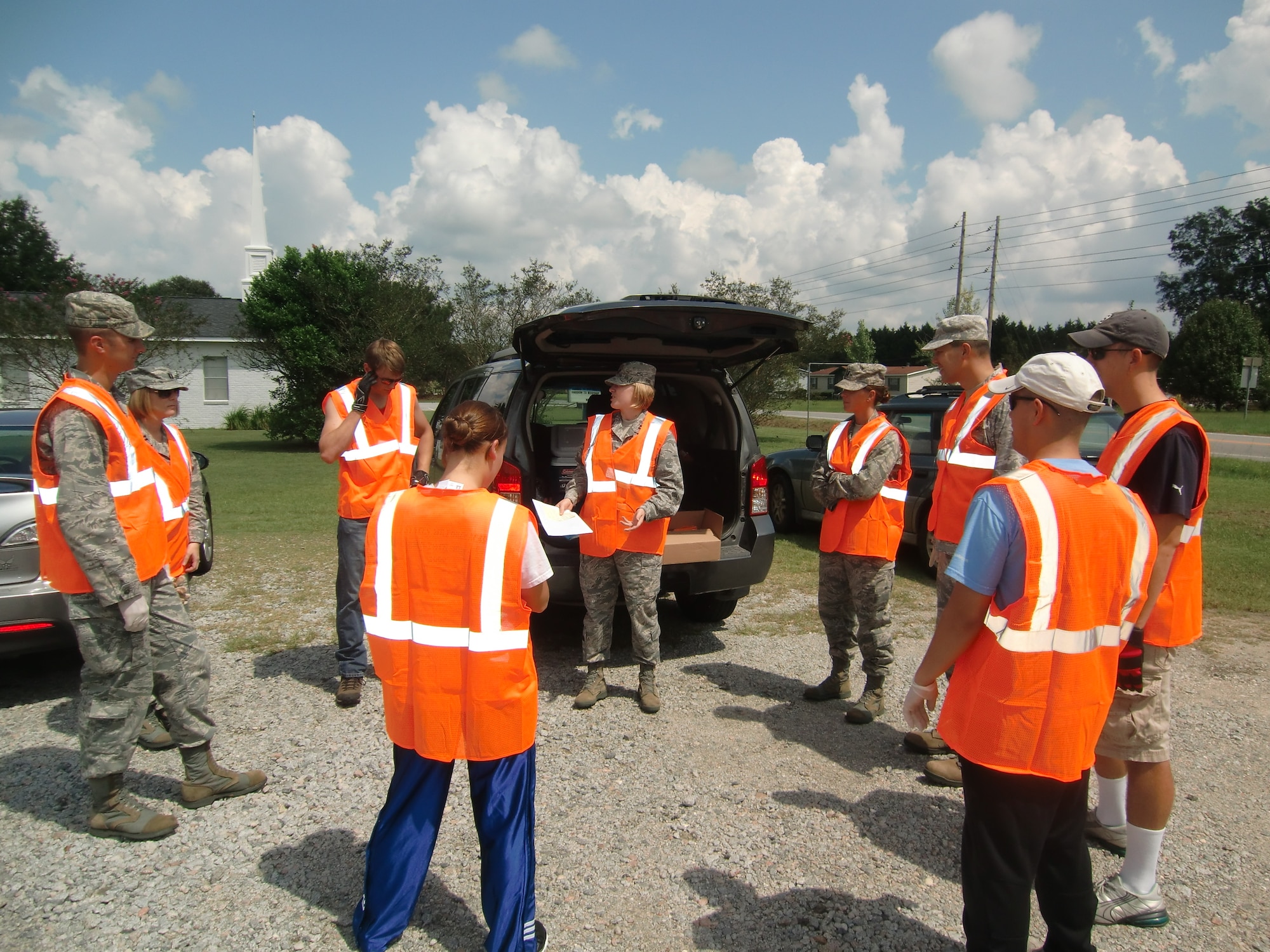 U.S. Air Force Capt. Claire Jarry, 20th Operations Support Squadron weather flight commander (center), gives a safety brief to Adopt-A-Highway volunteers from Shaw Air Force Base, S.C., Sept. 7, 2012. The participants are members of the Company Grade Officers Council, and cleaned up litter on both sides of a one-mile stretch of highway. (U.S. Air Force photo by 2nd Lt. Earon Brown/Released)