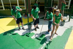 Airmen from Joint Base Charleston paint a courtyard Sept. 7, 2012, at Summerville High School in Summerville, S.C. The Day of Caring, organized locally by the Trident United Way, saw more than 8,500 volunteers working on more than 300 projects around the Lowcountry. (U.S. Air Force photo/Airman 1st Class Ashlee Galloway)