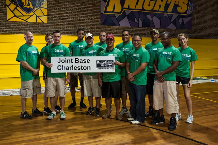 Airmen from Joint Base Charleston pose for a photo after painting bleachers Sept. 7, 2012, at Rollings Middle School of the Arts in Summerville, S.C. The Day of Caring, organized locally by the Trident United Way, saw more than 8,500 volunteers working on more than 300 projects around the Lowcountry, (U.S. Air Force photo/Airman 1st Class Ashlee Galloway)