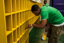 Senior Airman Dominique Dutton, 16th Airlift Squadron loadmaster, 437th Airlift Wing, paints a shelf Sept. 7, 2012, at Rollings Middle School of the Arts in Summerville, S.C. The Day of Caring, organized locally by the Trident United Way, saw more than 8,500 volunteers working on more than 300 projects around the Lowcountry. (U.S. Air Force photo/Airman 1st Class Ashlee Galloway)