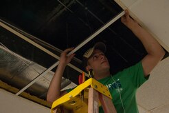 Staff Sgt. Marcus Maltese, 628th Aerospace Medicine Squadron Bioenvironmental Engineering flight, replaces ceiling tiles Sept. 7, 2012, at Rollings Middle School of the Arts in Summerville, S.C. The Day of Caring, organized locally by the Trident United Way, saw more than 8,500 volunteers working on more than 300 projects around the Lowcountry. (U.S. Air Force photo/Airman 1st Class Ashlee Galloway)