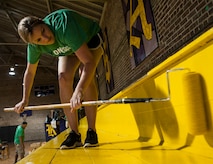 Tech. Sgt. Laci Brokaw, 628th Medical Group Dental Support noncommissioned officer, paints a bleacher Sept. 7, 2012, at Rollings Middle School of the Arts in Summerville, S.C. The Day of Caring, organized locally by the Trident United Way, saw more than 8,500 volunteers working on more than 300 projects around the Lowcountry. (U.S. Air Force photo/Airman 1st Class Ashlee Galloway)