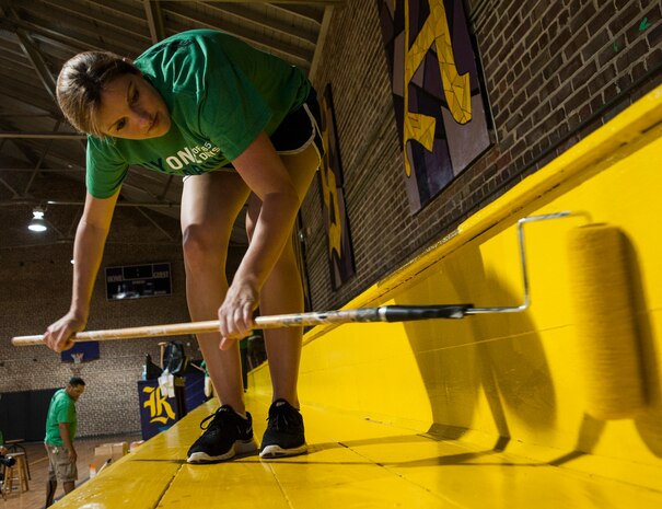 Tech. Sgt. Laci Brokaw, 628th Medical Group Dental Support noncommissioned officer, paints a bleacher Sept. 7, 2012, at Rollings Middle School of the Arts in Summerville, S.C. The Day of Caring, organized locally by the Trident United Way, saw more than 8,500 volunteers working on more than 300 projects around the Lowcountry. (U.S. Air Force photo/Airman 1st Class Ashlee Galloway)
