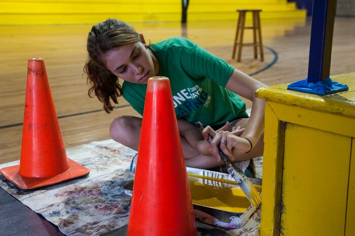 Airmen 1st Class Natalie Jones, 628th Aerospace Medicine Squadron Bioenvironmental Engineering flight, paints a bleacher Sept. 7, 2012, at Rollings Middle School of the Arts in Summerville, S.C. The Day of Caring, organized locally by the Trident United Way, saw more than 8,500 volunteers working on more than 300 projects around the Lowcountry. (U.S. Air Force photo/Airman 1st Class Ashlee Galloway)