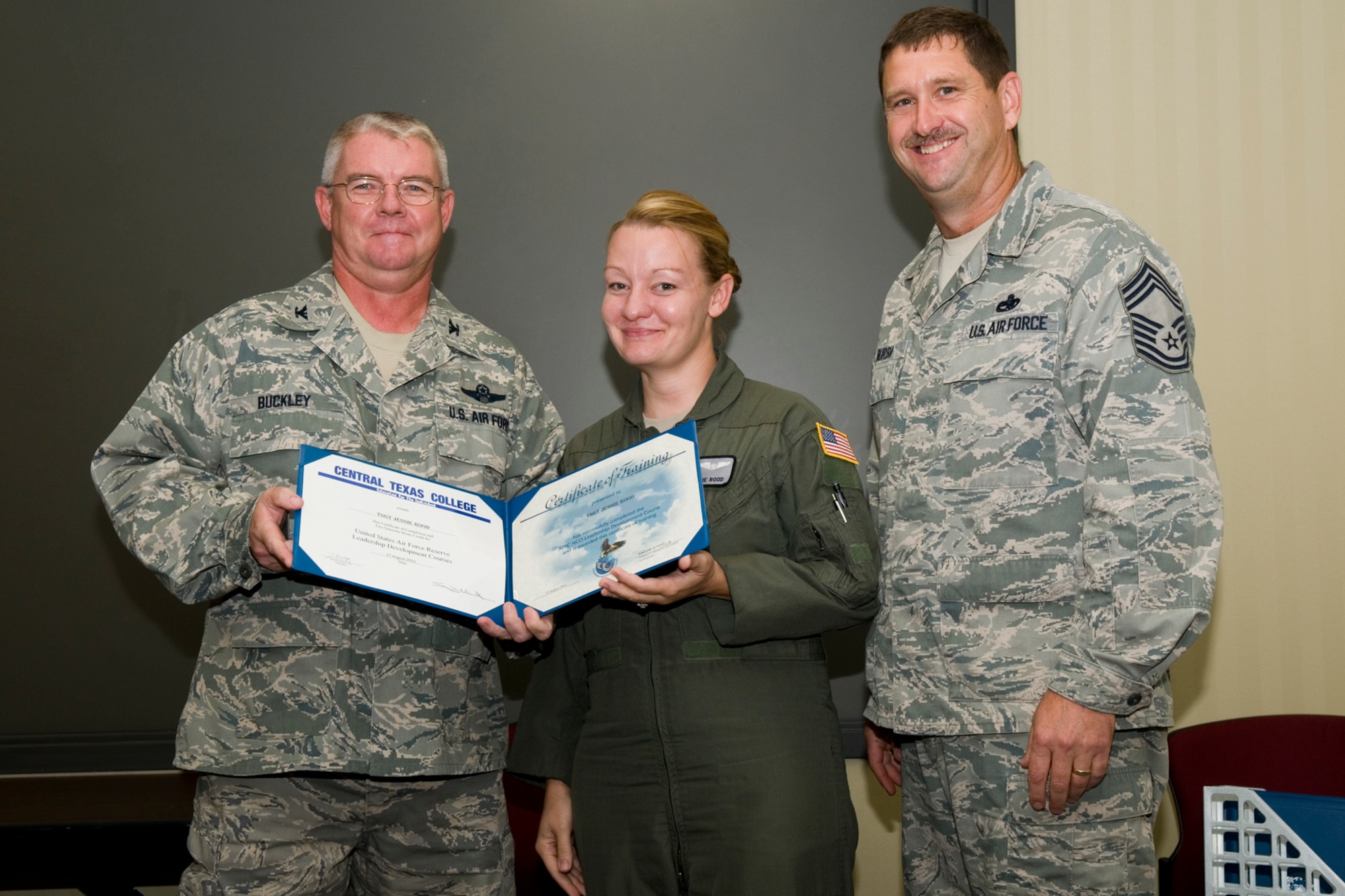 GRISSOM AIR RESERVE BASE, Ind. -- Tech. Sgt. Jessie Rood, 434th Operations Support Squadron in-flight refueling technician, receives a certificate of training from Col. Don Buckley, 434th Air Refueling Wing commander, and Chief Master Sergeant James Burba, 434th Maintenance Operations Flight maintenance superintendent, at a graduation ceremony for a Non-Commissioned Officer Leadership Development Course here Aug. 17. Rood graduated the course with 20 other NCOs. (U.S. Air Force photo/Senior Airman Andrew McLaughlin)