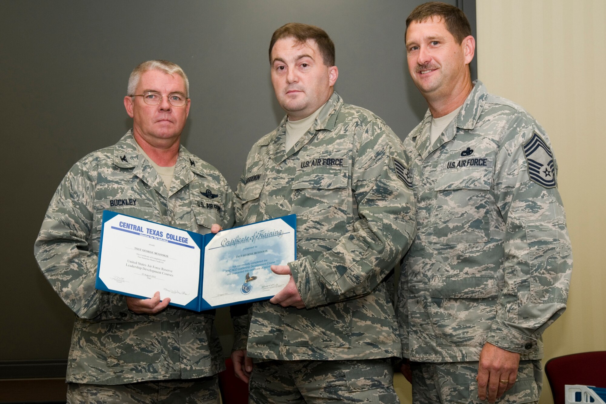 GRISSOM AIR RESERVE BASE, Ind. -- Tech. Sgt. George McGookin, 434th Maintenance Squadron knowledge operations manager, receives a certificate of training from Col. Don Buckley, 434th Air Refueling Wing commander, and Chief Master Sergeant James Burba, 434th Maintenance Operations Flight maintenance superintendent, at a graduation ceremony for a Non-Commissioned Officer Leadership Development Course here Aug. 17. McGookin graduated the course with 20 other NCOs. (U.S. Air Force photo/Senior Airman Andrew McLaughlin)