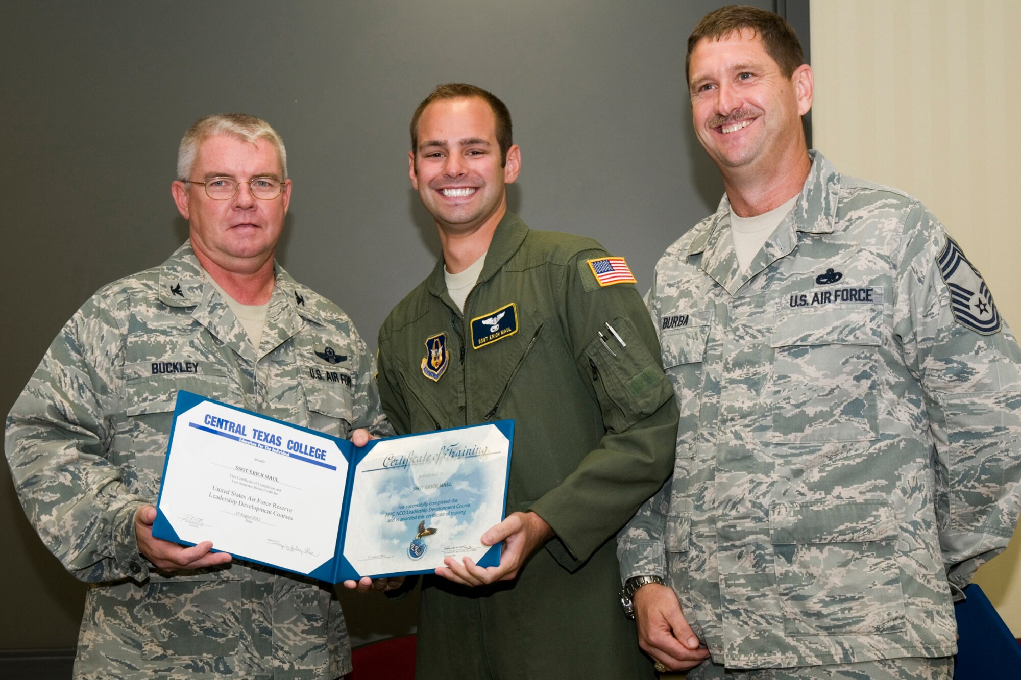 GRISSOM AIR RESERVE BASE, Ind. -- Staff Sgt. Erich Maul, 72nd Air Refueling Squadron in-flight refueling technician, receives a certificate of training from Col. Don Buckley, 434th Air Refueling Wing commander, and Chief Master Sergeant James Burba, 434th Maintenance Operations Flight maintenance superintendent, at a graduation ceremony for a Non-Commissioned Officer Leadership Development Course here Aug. 17. Maul graduated the course with 20 other NCOs. (U.S. Air Force photo/Senior Airman Andrew McLaughlin)