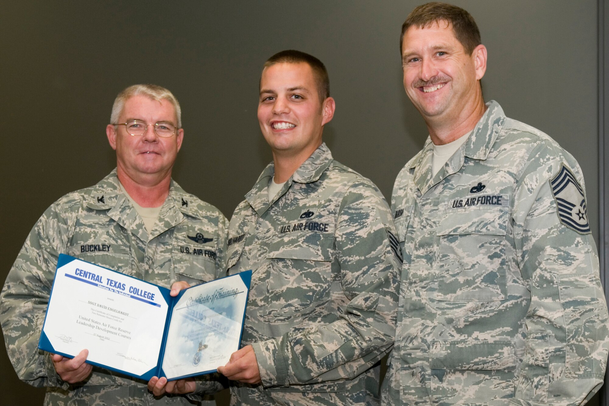 GRISSOM AIR RESERVE BASE, Ind. -- Staff Sgt. David Engelhardt, 434th Aircraft Maintenance Squadron KC-135 crew chief, receives a certificate of training from Col. Don Buckley, 434th Air Refueling Wing commander, and Chief Master Sergeant James Burba, 434th Maintenance Operations Flight maintenance superintendent, at a graduation ceremony for a Non-Commissioned Officer Leadership Development Course here Aug. 17. Engelhardt graduated the course with 20 other NCOs. (U.S. Air Force photo/Senior Airman Andrew McLaughlin)